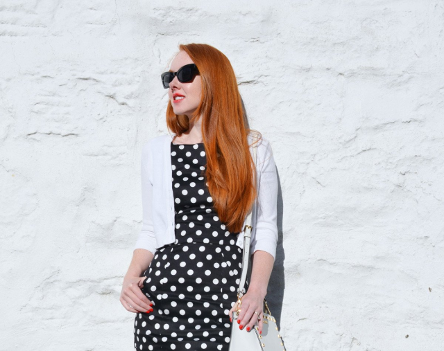 A polka dot dress combined with a white cardigan